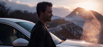 A man standing next to the  all-new Mazda CX-60 Plug-In Hybrid SUV.