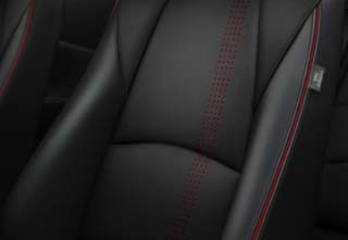 The Black Cloth seat & Black leather Seat Bolster/Back with red stitch + piping of the Mazda2 Homura-AKA grade