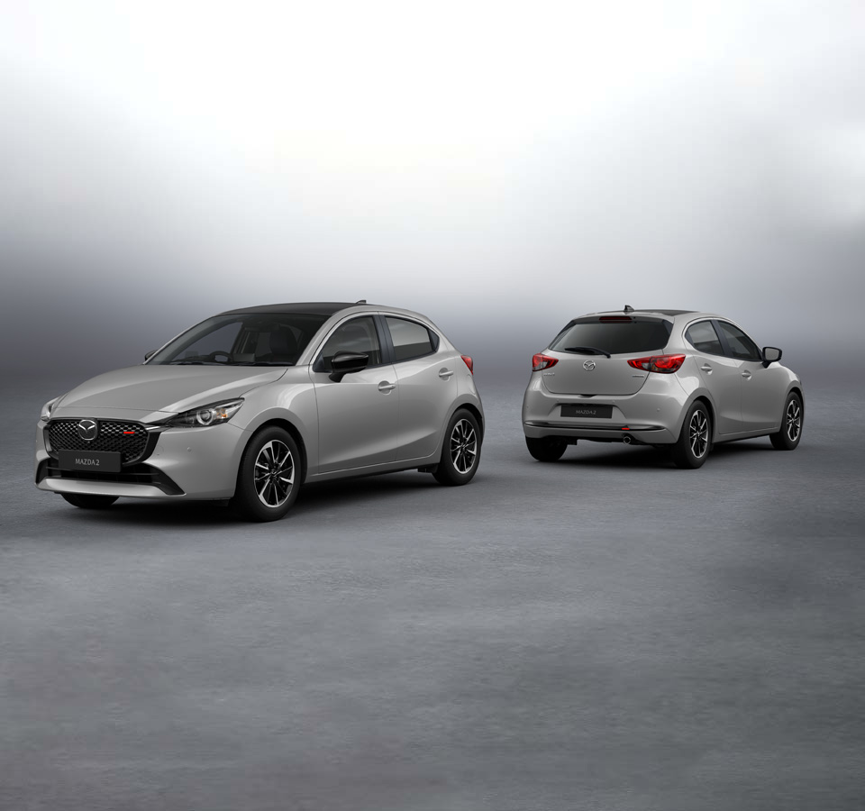 Two silver Mazda2 parked next to each other, shown from the front and rear.