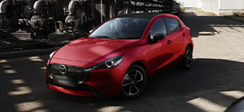 A red Mazda2 pictured from the front.