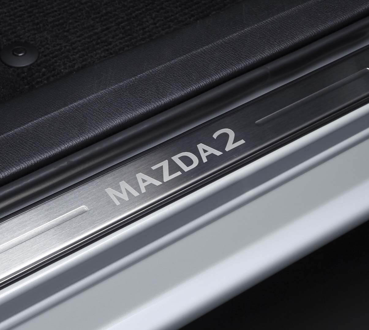 Stylish scuff plates protect your Mazda2 door sills from scratches and scuffs.