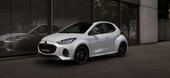 Mazda2 Hybrid parkeret foran en bygning.