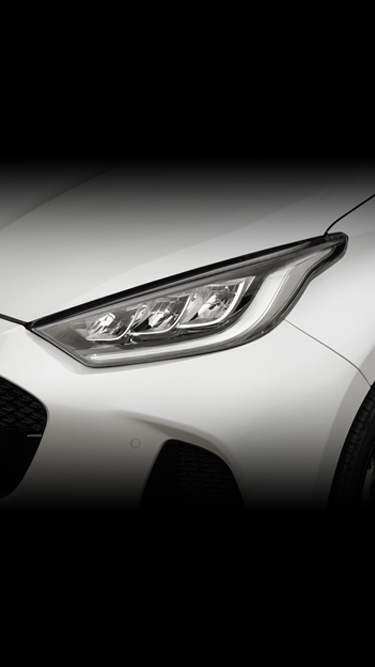 The headlight and tail lights of the Mazda2 Hybrid in white.