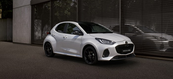 The Mazda2 Hybrid parked in front a building.