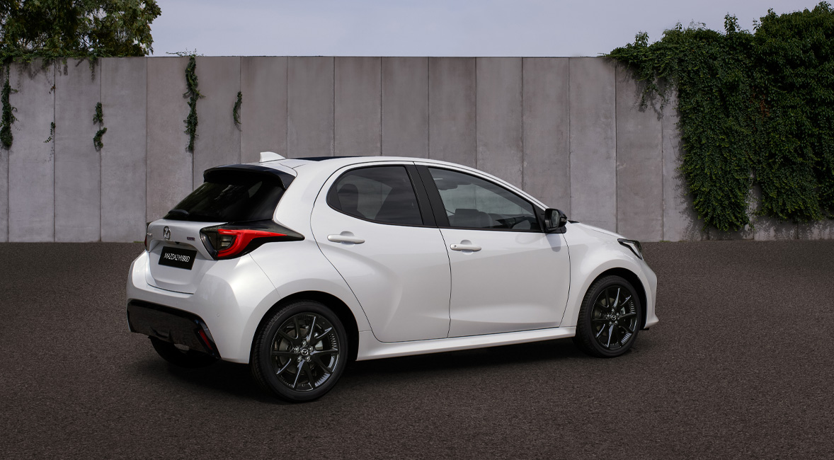 The Mazda2 Hybrid in white parked in the streets.