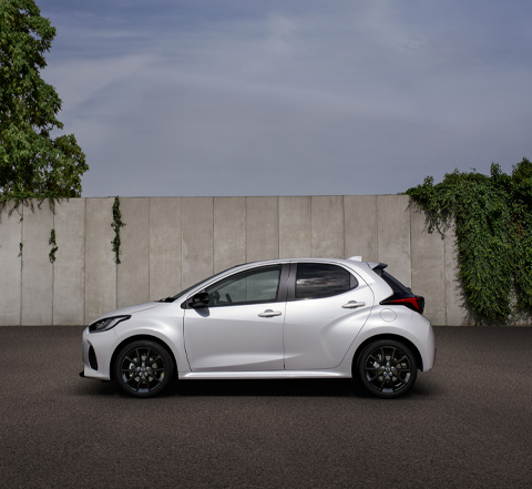 The Mazda2 Hybrid parked in front a wall.