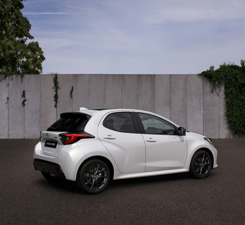 The Mazda2 Hybrid in white parked in the streets.