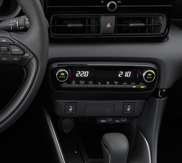 The dashboard and automatic climate controls of the Mazda2 Hybrid.