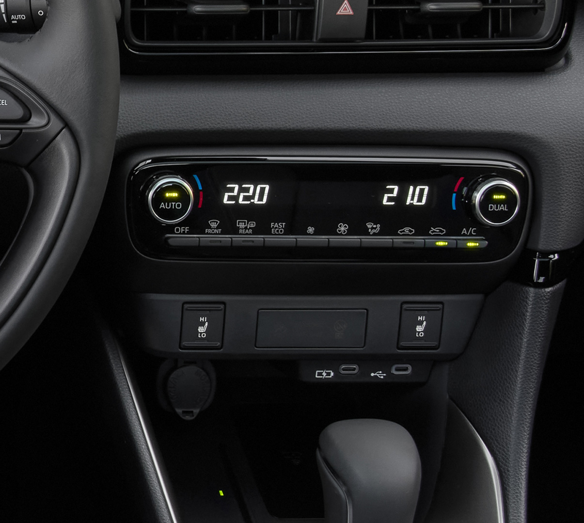 The dashboard and automatic climate controls of the Mazda2 Hybrid.