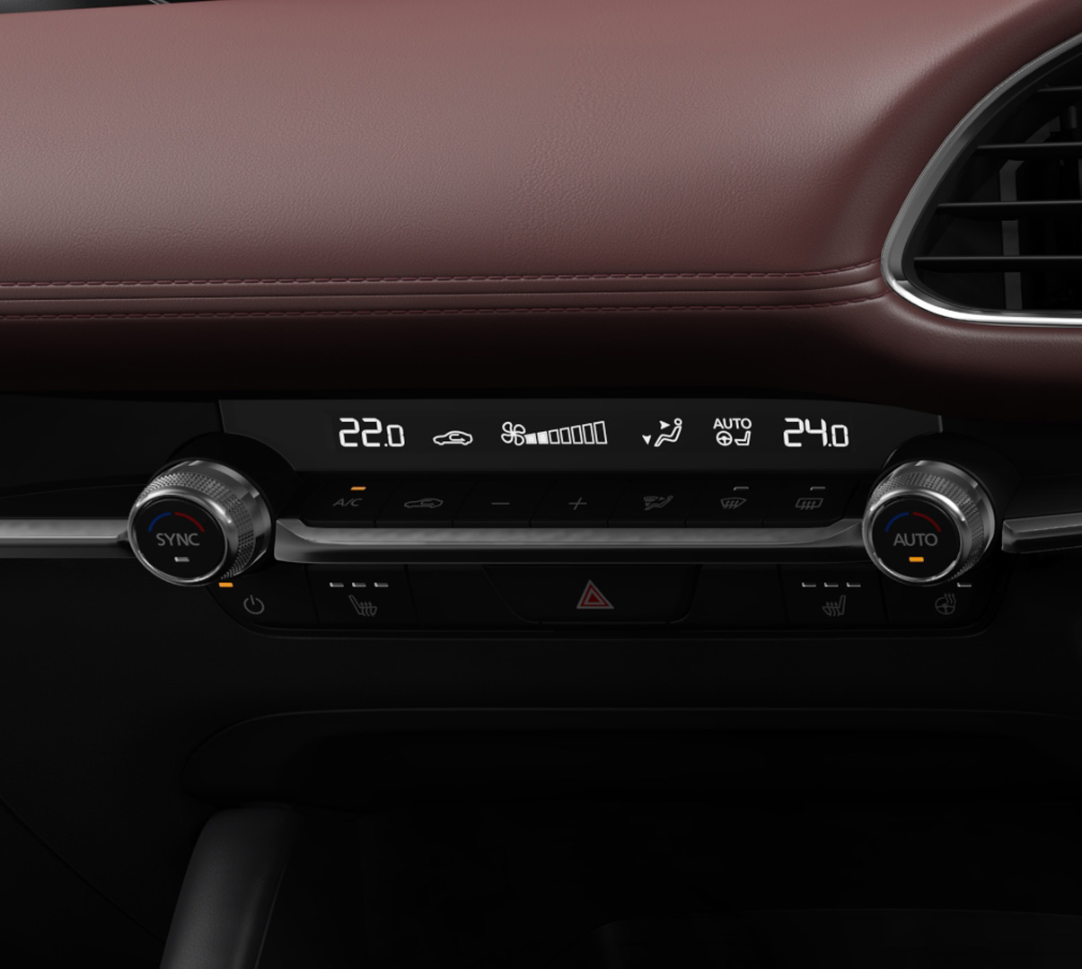 The round controls of the automatic air conditioning system of the Mazda3.