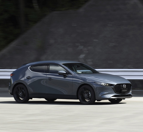 A grey Madza 3 Saloon shown from the side.