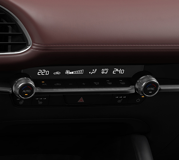 The round controls of the automatic air conditioning system of the Mazda3.