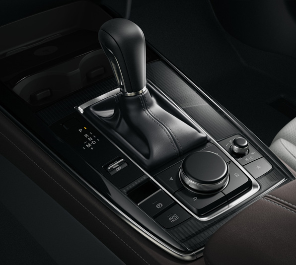 The center console of the Mazda CX-30 with gear shifter and HMI Commander dial.