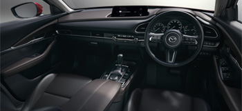 Interior view of the Mazda CX-30 showing the front seats and dashboard.