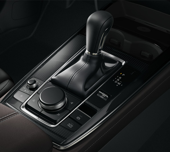 The center console of the Mazda CX-30 with gear shifter and HMI Commander dial.