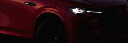 The Mazda Finance logo and headlights of the Mazda CX-60