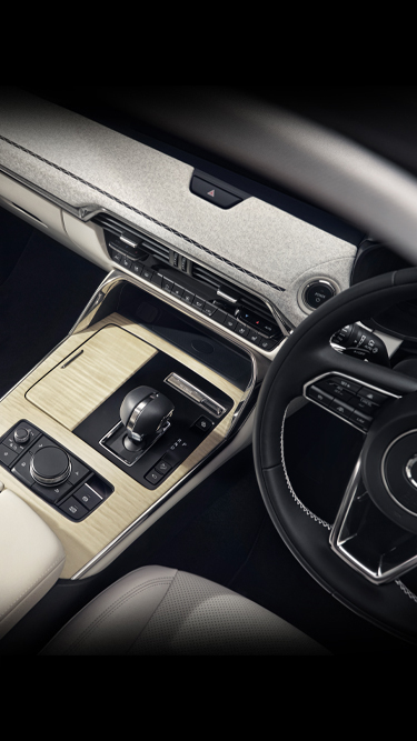 The interior of the Mazda CX-60 Plug-In Hybrid SUV featuring maple wood trim and Japanese fabrics.