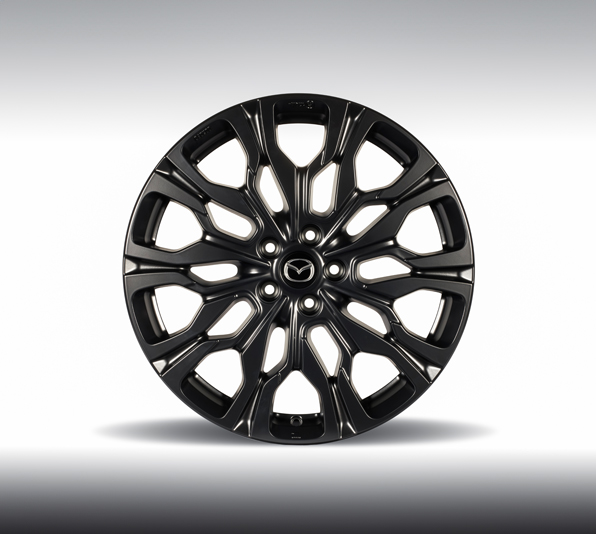 A black alloy wheel of the Mazda CX-80.