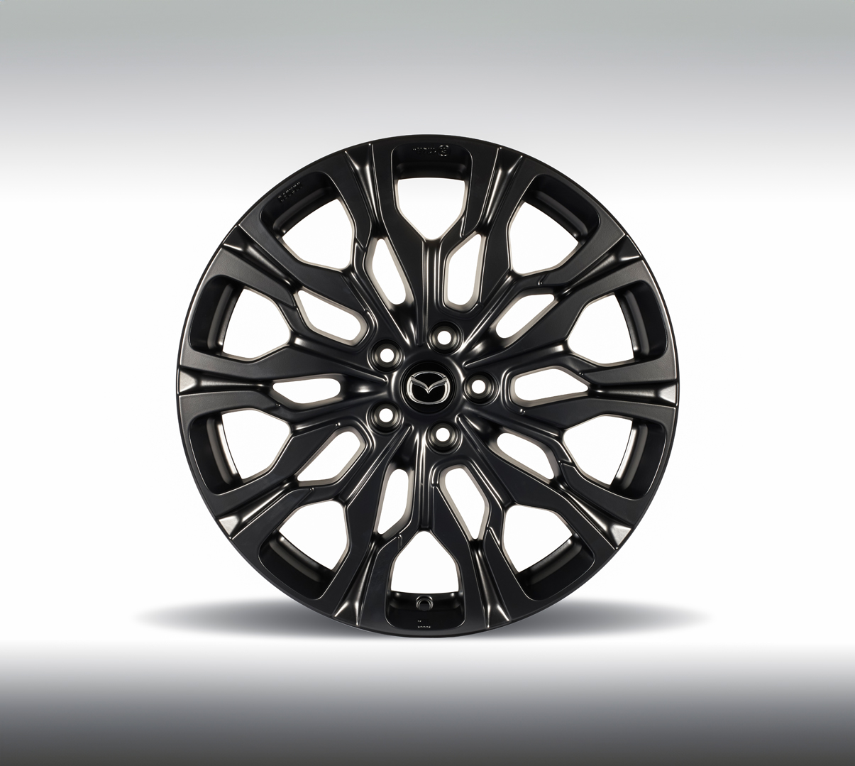 A black alloy wheel of the Mazda CX-80.