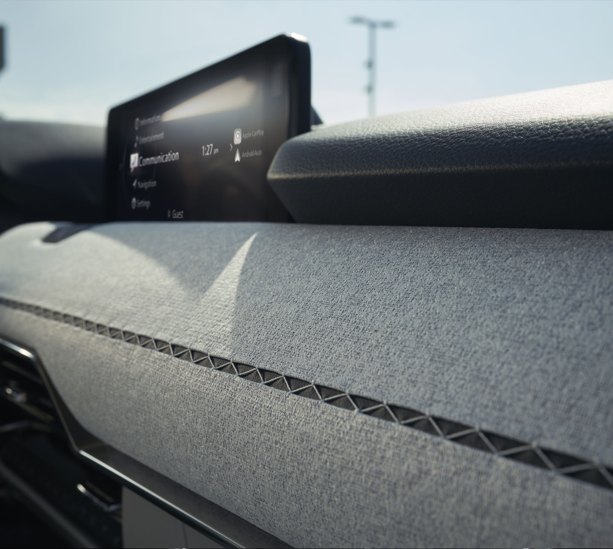 Dashboard covered in Japanese hanging stitch fabric inside the Mazda CX-80's cabin.