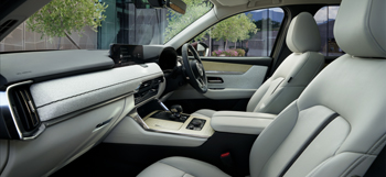 The inside view of the cockpit of the Mazda CX-80 and its seats.