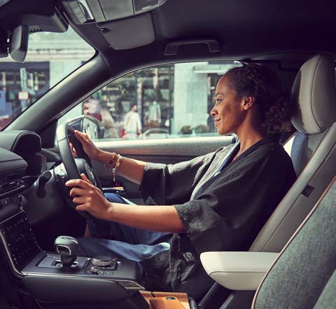 A woman at the wheel of the Mazda MX-30.