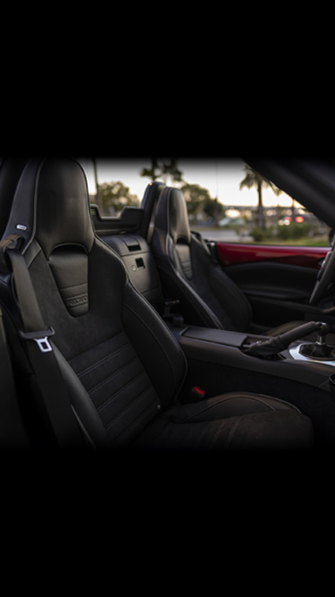 Black Recaro seats inside the Mazda MX-5's cockpit.