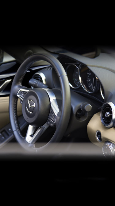 The leather wrapped steering wheel inside the Mazda MX-5's cockpit.