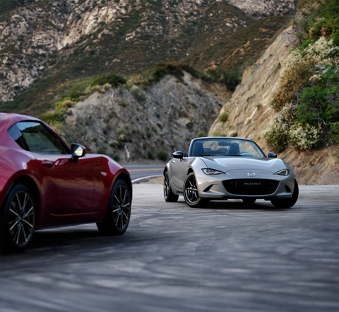 The Mazda MX-5 Roadster and the Mazda MX-5 RF parked in front of each other.