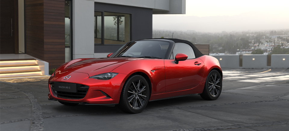 The Mazda MX-5 Roadster parked in front of a modern house.