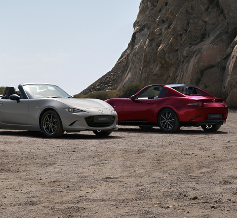 The Mazda MX-5
 Roadster and the Mazda MX-5
 RF parked next to each other at the beach.