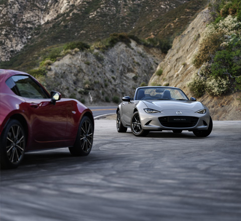 The Mazda MX-5
 Roadster and the Mazda MX-5
 RF parked in front of each other.