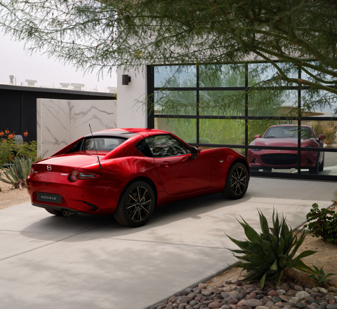 The Mazda MX-5
 RF in red parked in front of a mirror wall.